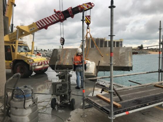 Razor Asbestos team using crane and tools for industrial demolition at a port facility in Queensland.
