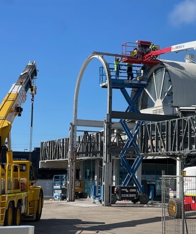 Licensed Razor Asbestos technicians using elevated platforms and crane to dismantle asbestos-contaminated industrial structure in Queensland.