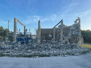Demolished structure with rubble and exposed framework, showcasing Razor Asbestos’ commercial and industrial demolition services.