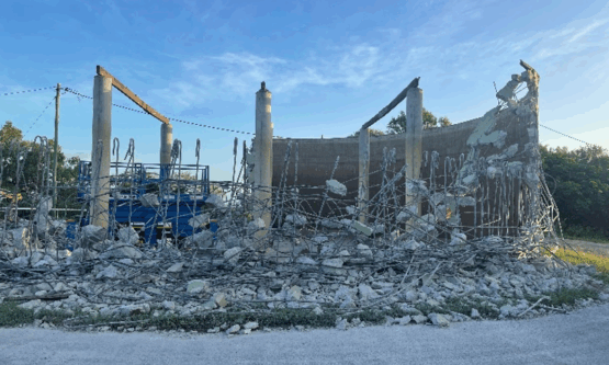 Demolished remains of the Mt Basset Water Reservoir with rubble and cleared site in view.